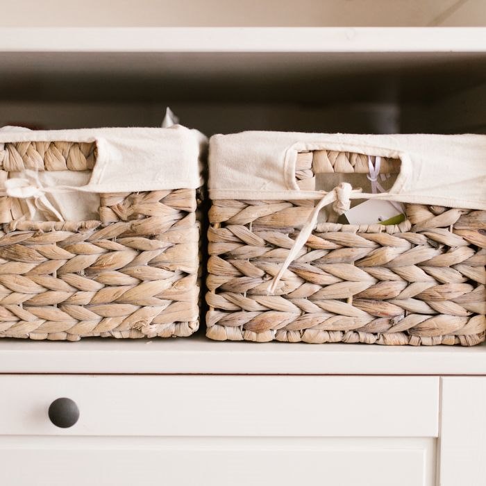 Organized home shelf with baskets and storage containers